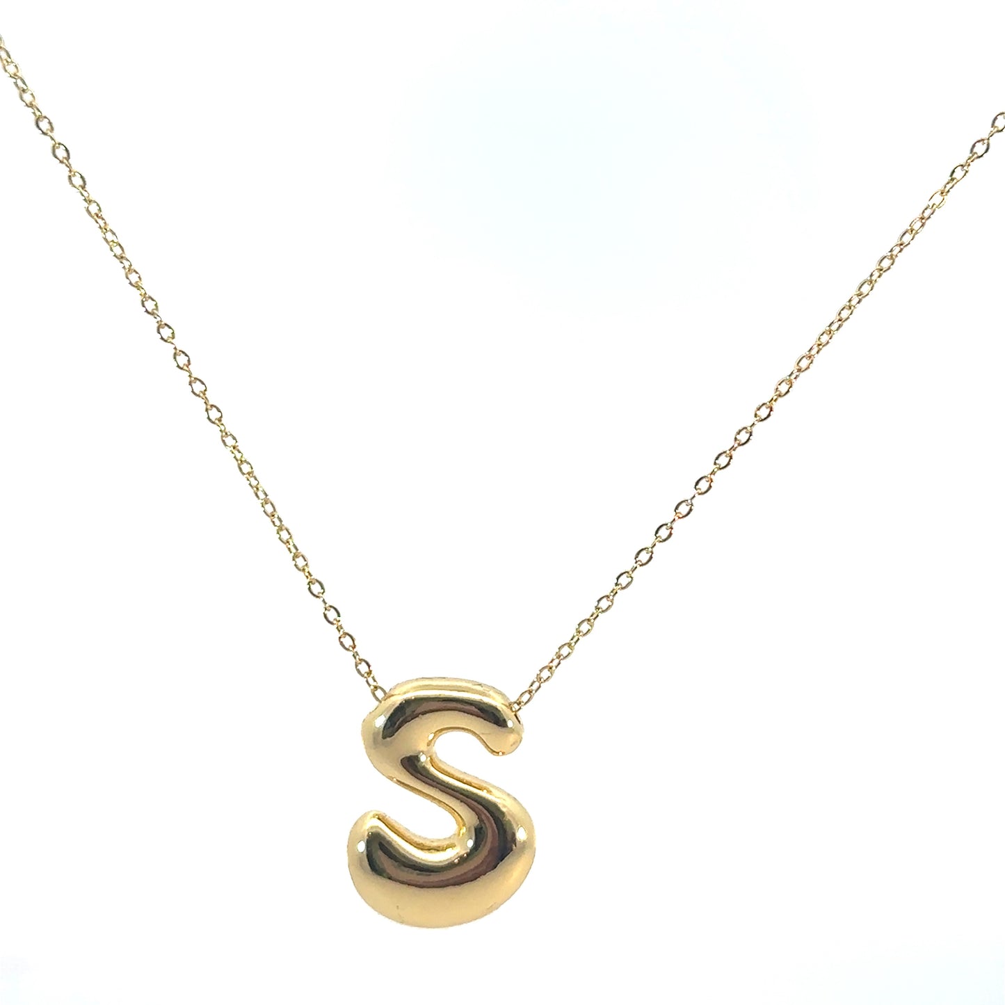Gold necklace with a letter 'S' pendant on a white background