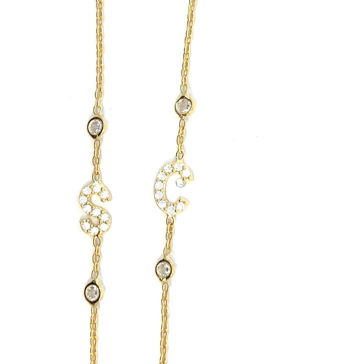 Gold necklace with small diamonds on a white background